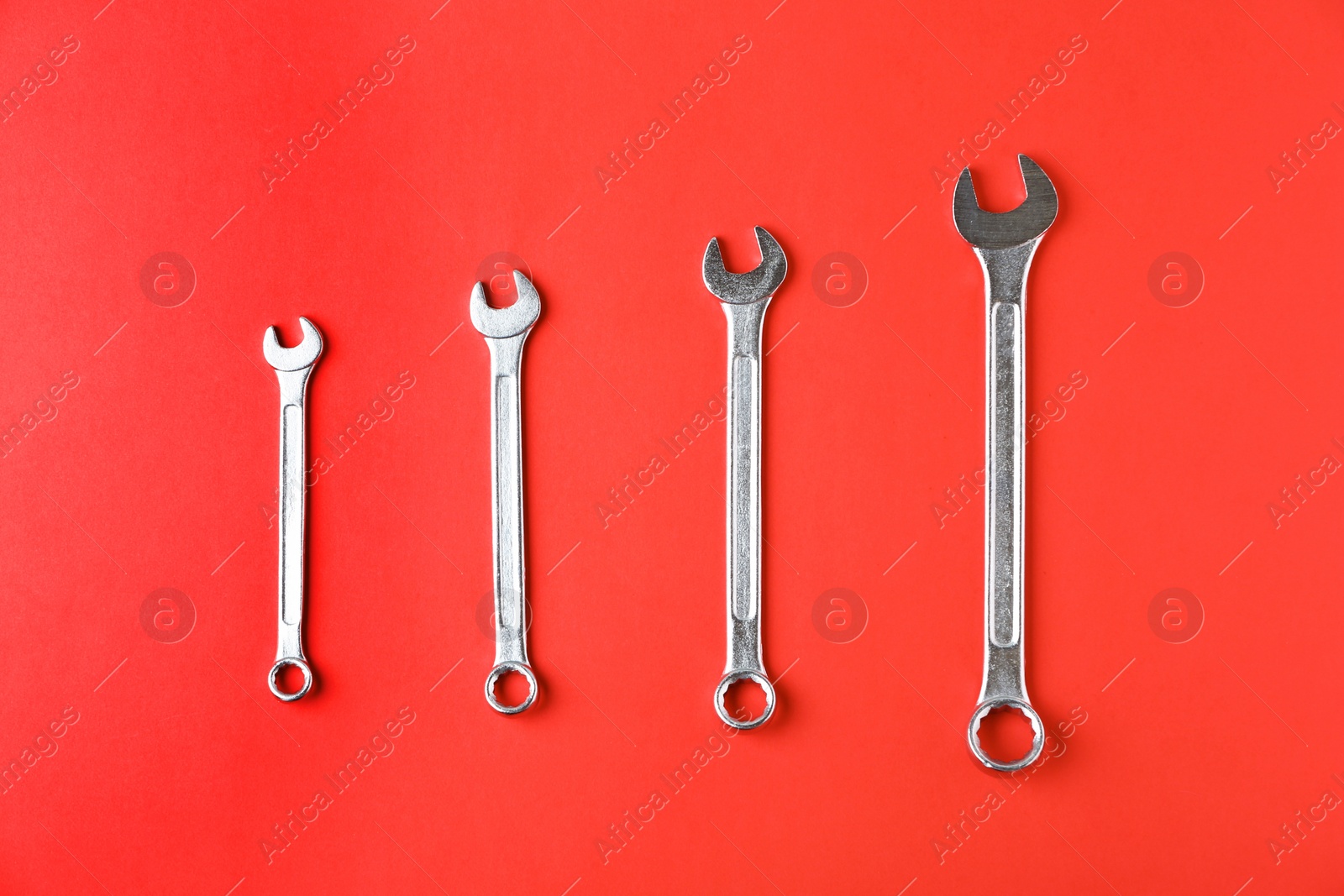 Photo of New wrenches on color background, top view. Plumber tools