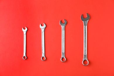 New wrenches on color background, top view. Plumber tools