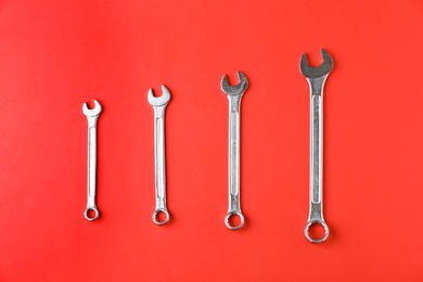 Photo of New wrenches on color background, top view. Plumber tools