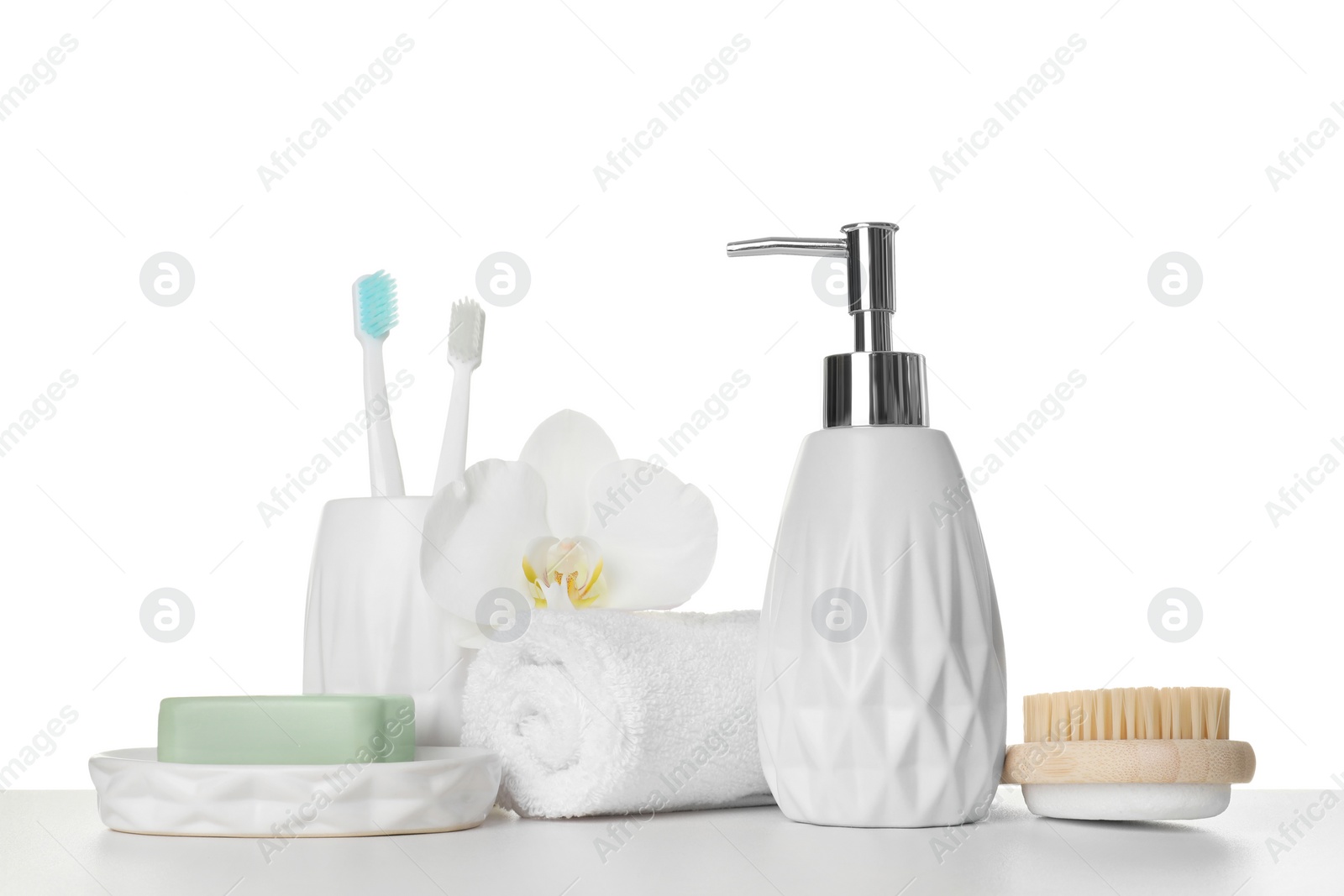 Photo of Bath accessories. Different personal care products and flower on table against white background