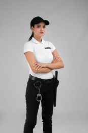 Photo of Female security guard in uniform on color background