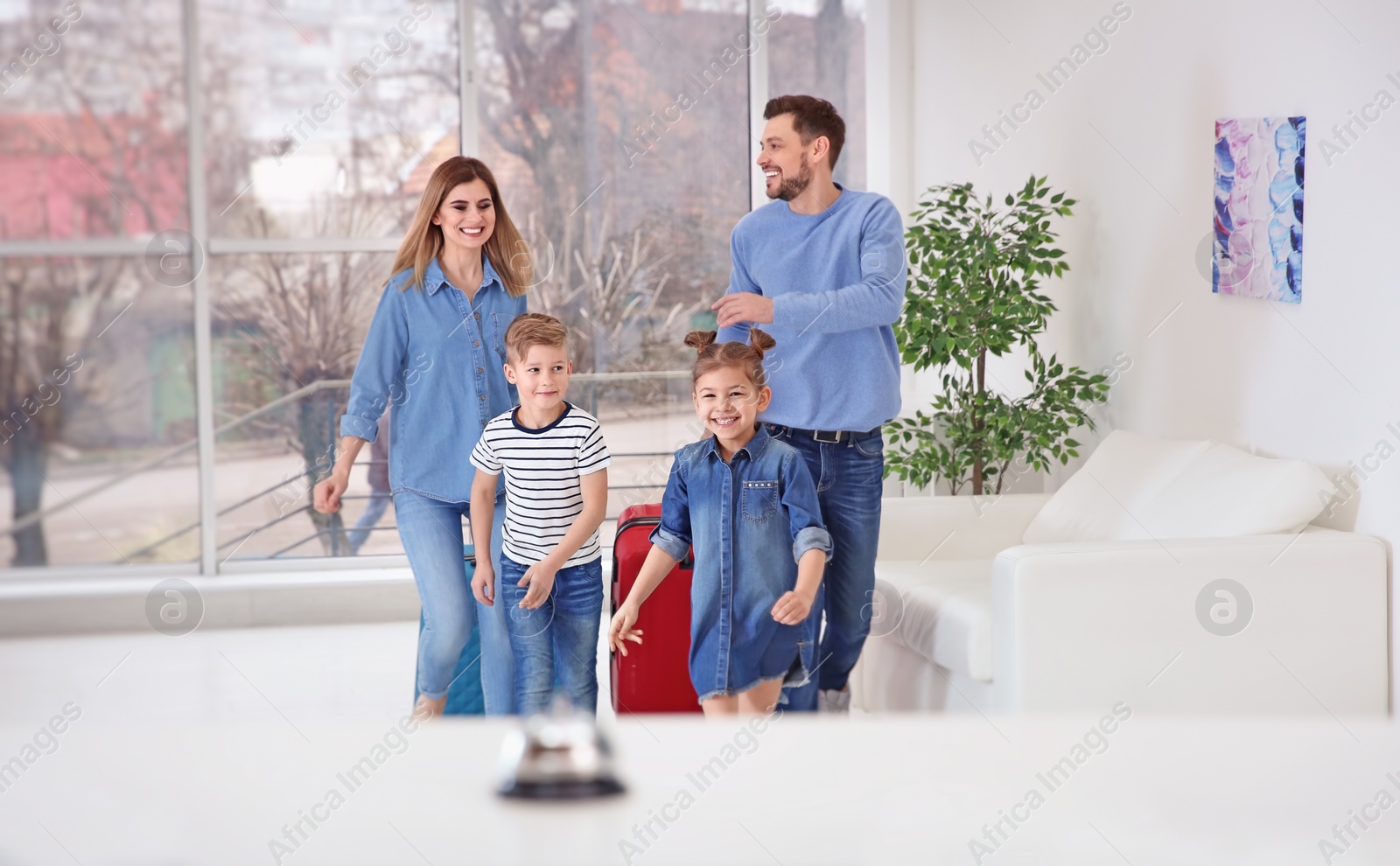 Photo of Happy family arriving in hotel