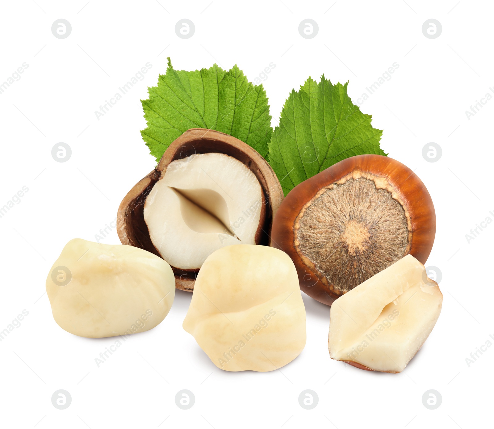 Image of Tasty hazelnuts and green leaves on white background