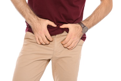 Photo of Man scratching crotch on white background, closeup. Annoying itch