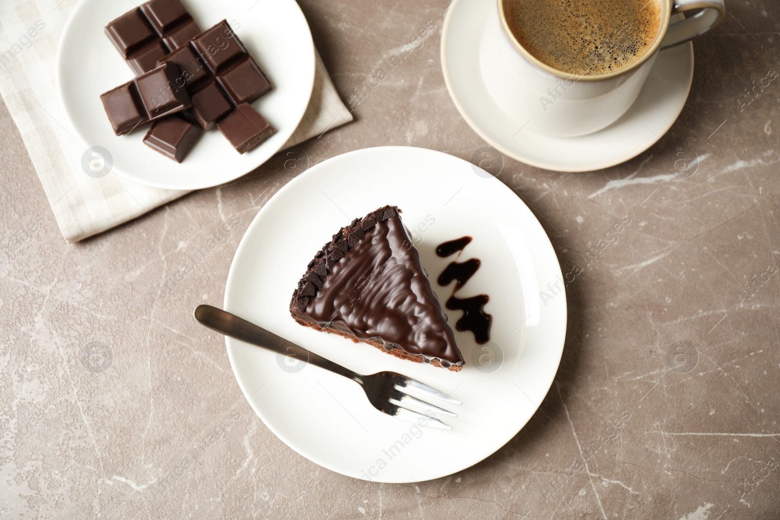 Photo of Tasty chocolate cake served on grey marble table, flat lay