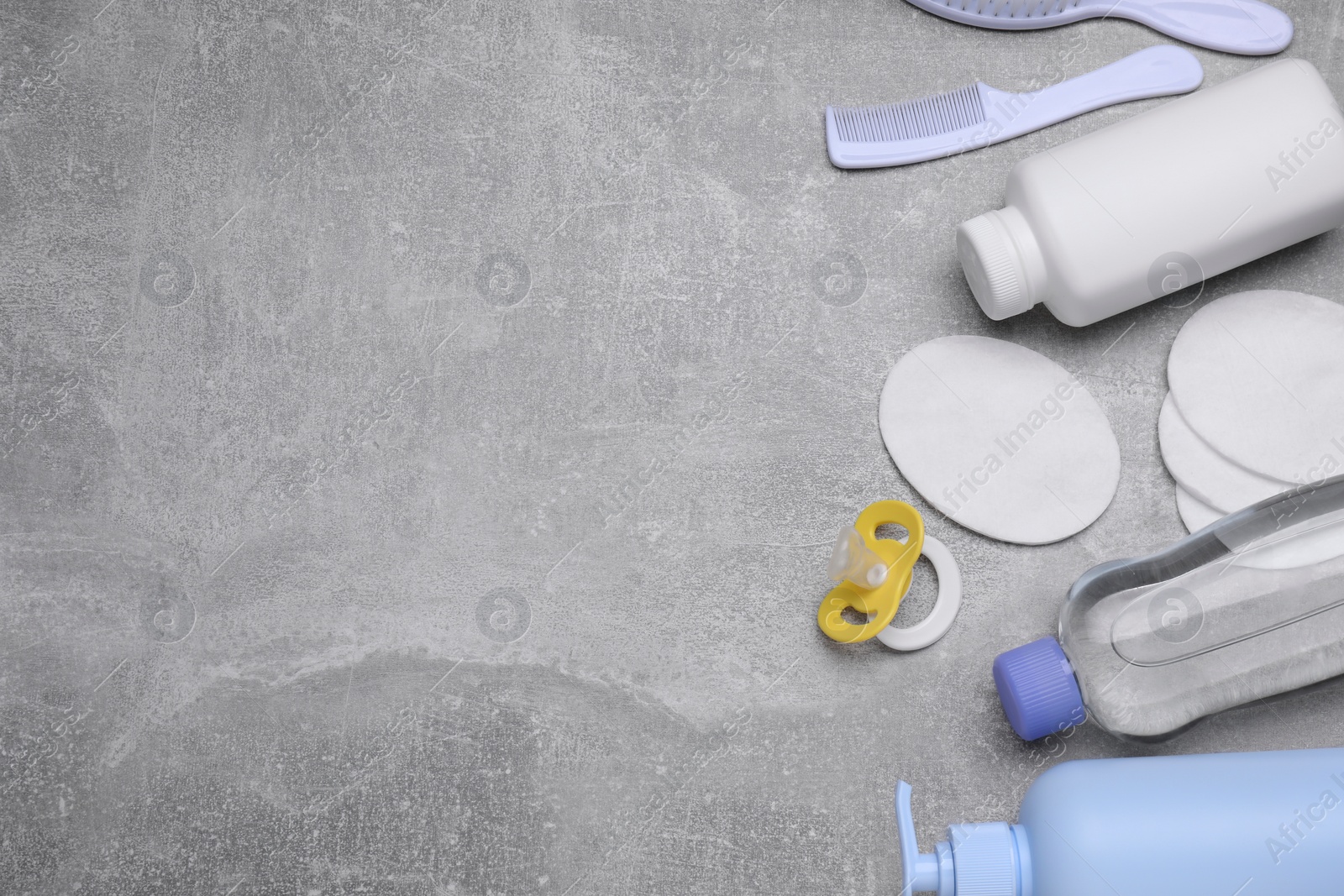 Photo of Flat lay composition with baby care products on grey table, space for text