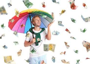 Man with umbrella under money rain on white background 