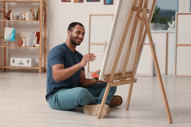 Photo of Young man painting in studio. Creative hobby