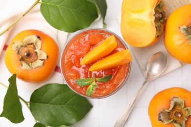 Delicious dessert with persimmon on table, flat lay