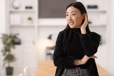 Photo of Portrait of smiling businesswoman in office. Space for text