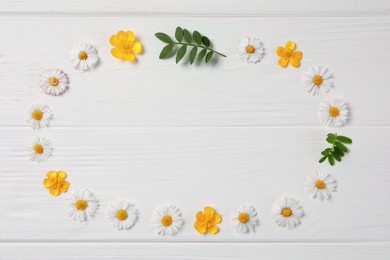 Photo of Frame of flowers and leaves on white wooden background, flat lay. Space for text
