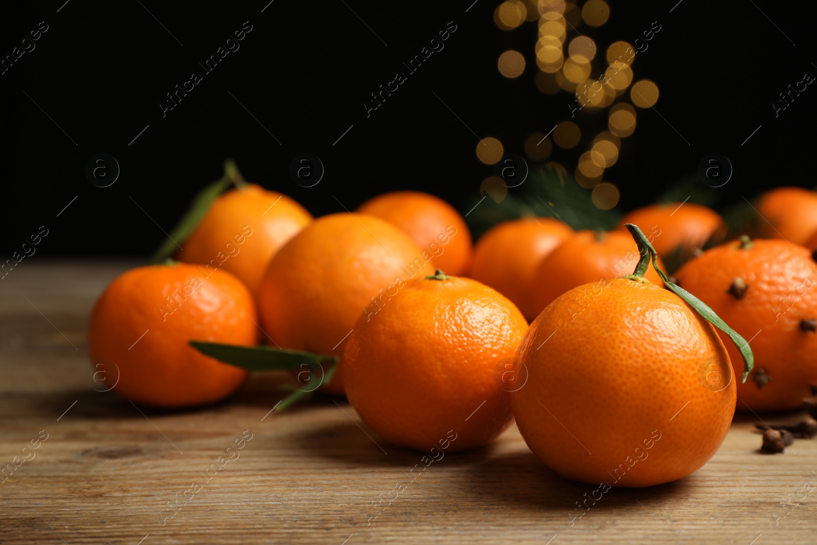 Photo of Fresh tangerines on wooden table, closeup. Christmas atmosphere