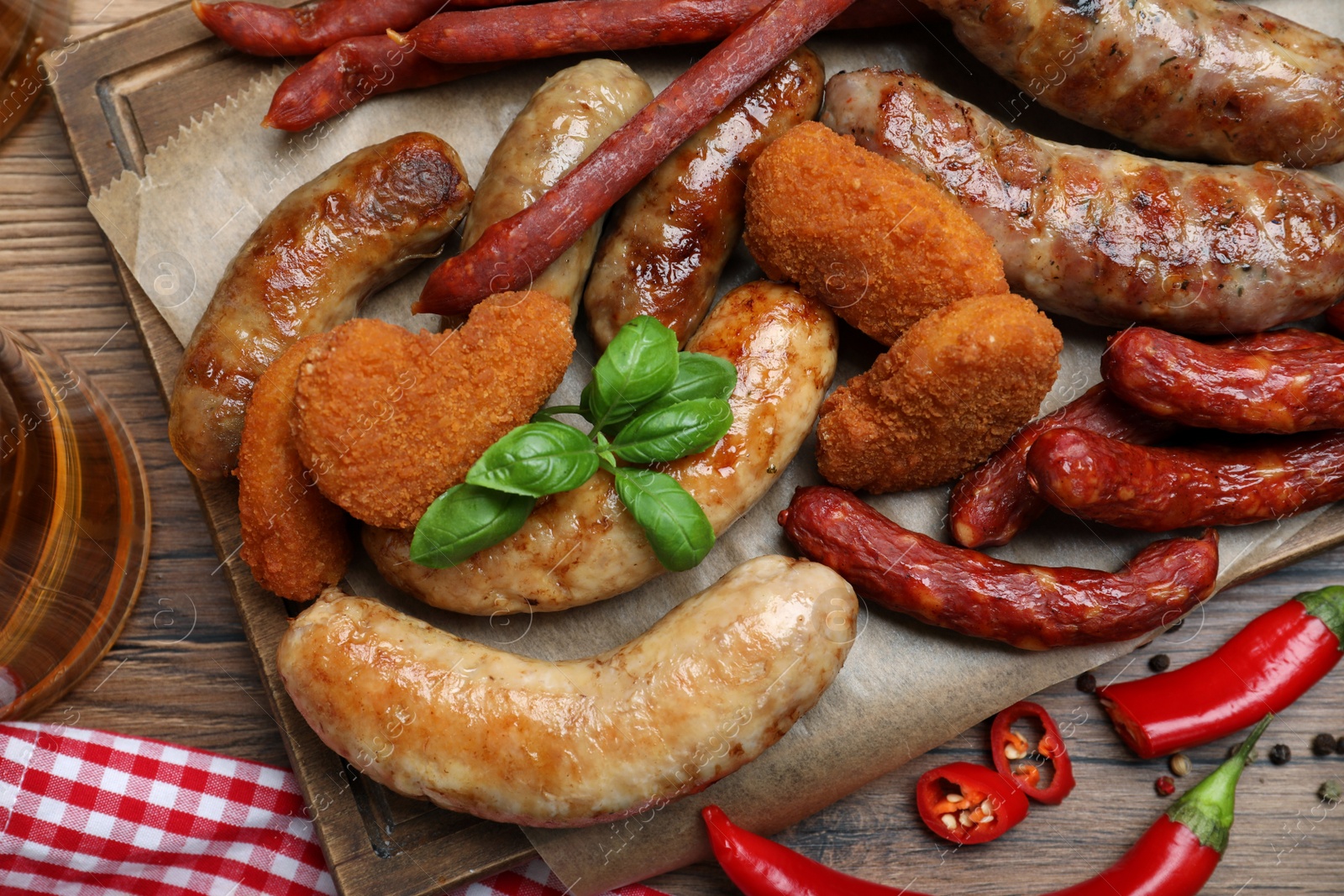 Photo of Set of different tasty snacks on wooden table, flat lay