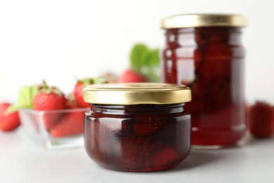 Delicious pickled strawberry jam and fresh berries on light table