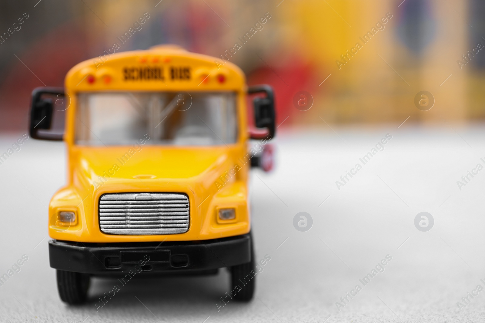 Photo of Closeup view of yellow toy school bus outdoors, space for text. Transport for students