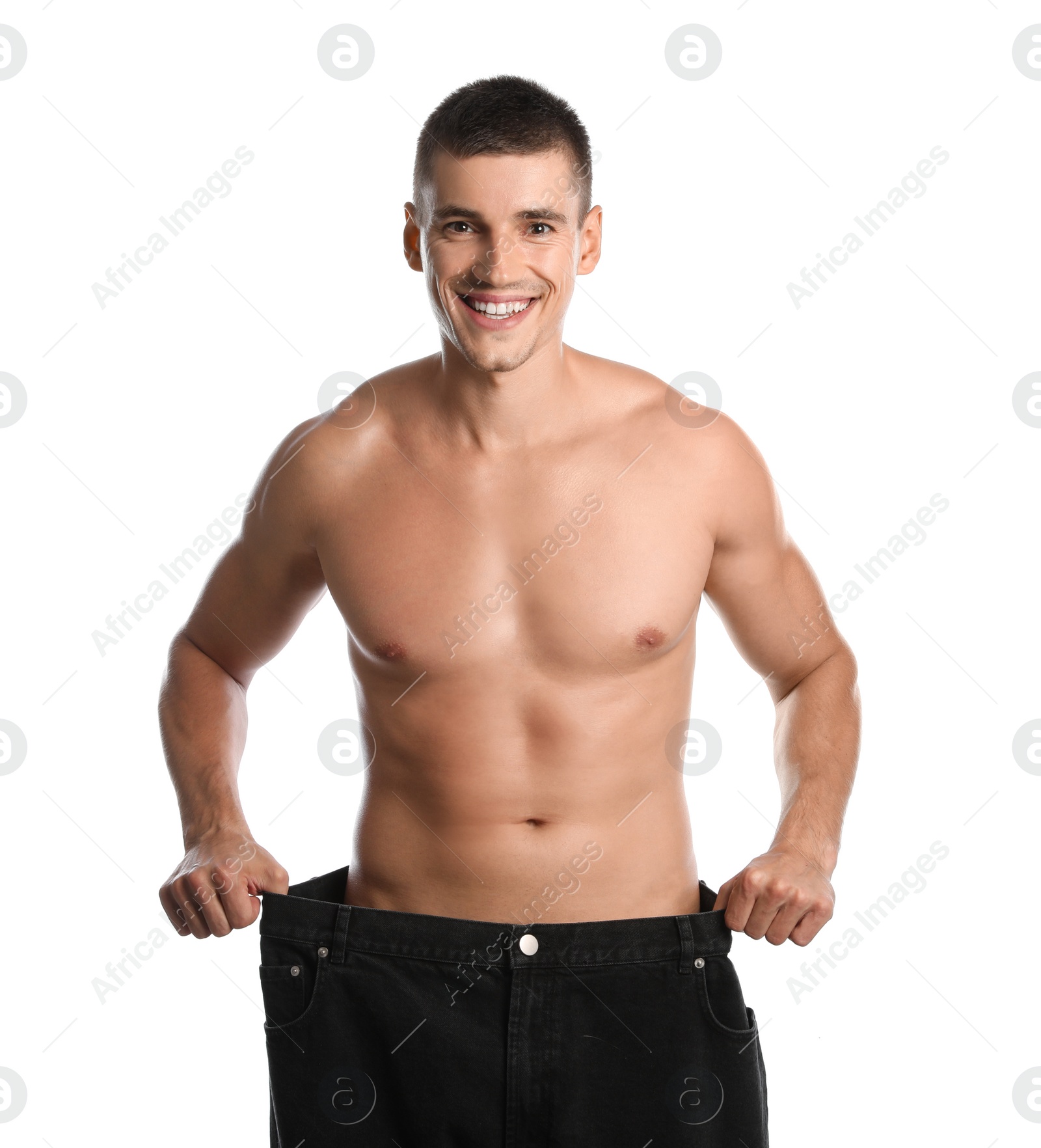 Photo of Young man with slim body in old big size jeans on white background