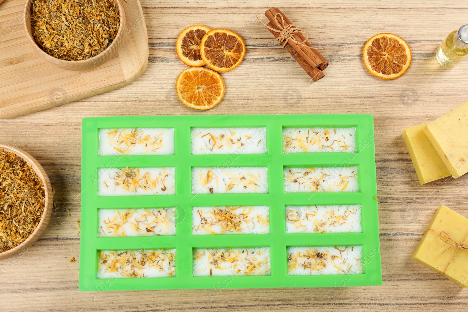 Photo of Flat lay composition with natural handmade soap and ingredients on wooden background