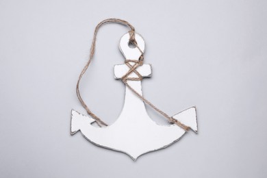 White wooden anchor figure on light background, top view
