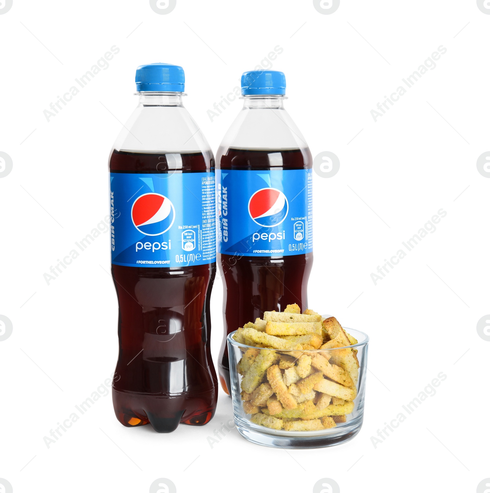 Photo of MYKOLAIV, UKRAINE - FEBRUARY 15, 2021: Plastic bottles of Pepsi and snack on white background