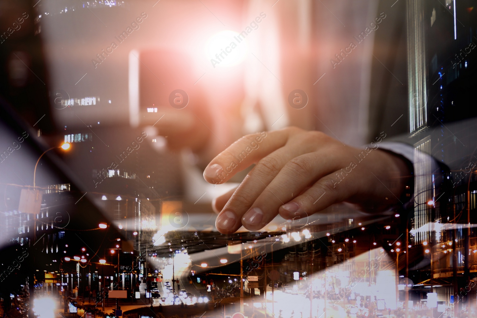 Image of Double exposure of male programmer using laptop and cityscape, closeup 