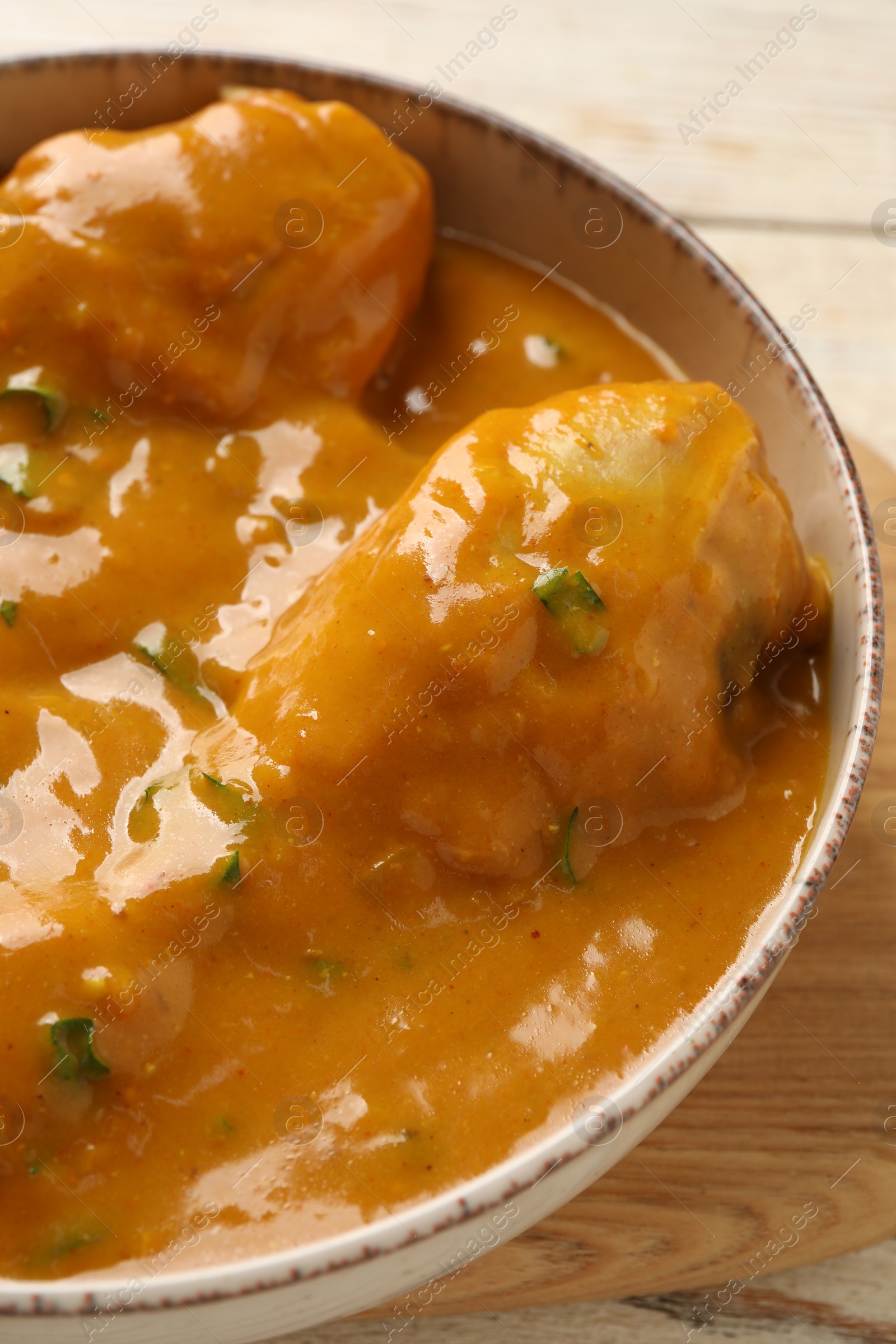 Photo of Tasty chicken curry on wooden table, closeup