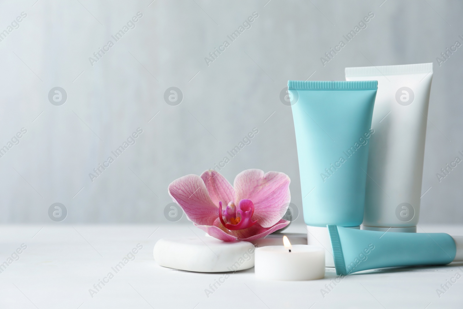 Photo of Composition with cosmetic products on white table. Space for text