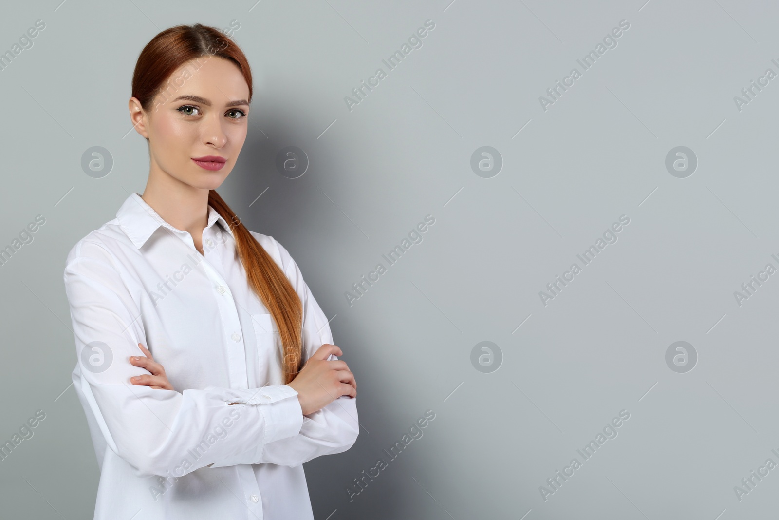 Photo of Portrait of beautiful young woman on light gray background, space for text