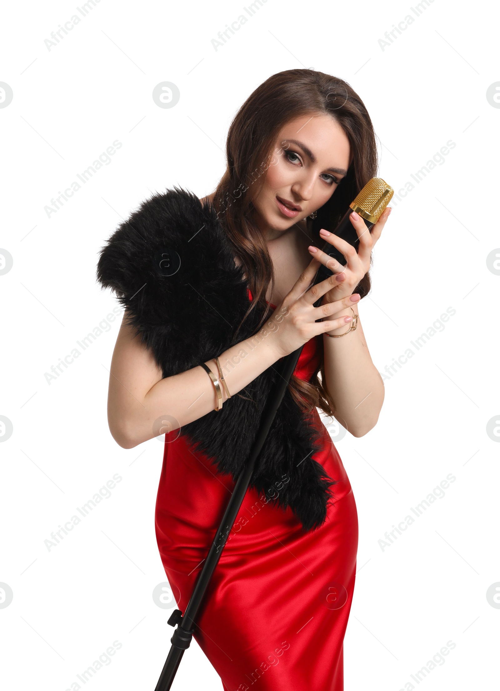 Photo of Beautiful young woman in stylish red dress with microphone singing on white background