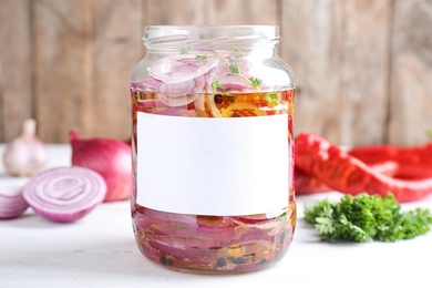 Photo of Jar of pickled onions with blank label on white table