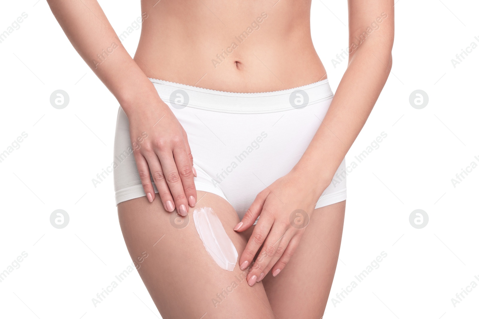 Photo of Woman with smear of body cream on her leg against white background, closeup