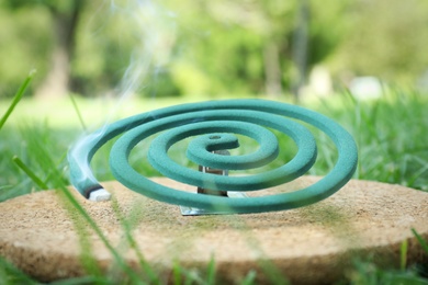Photo of Smouldering insect repellent coil on board outdoors