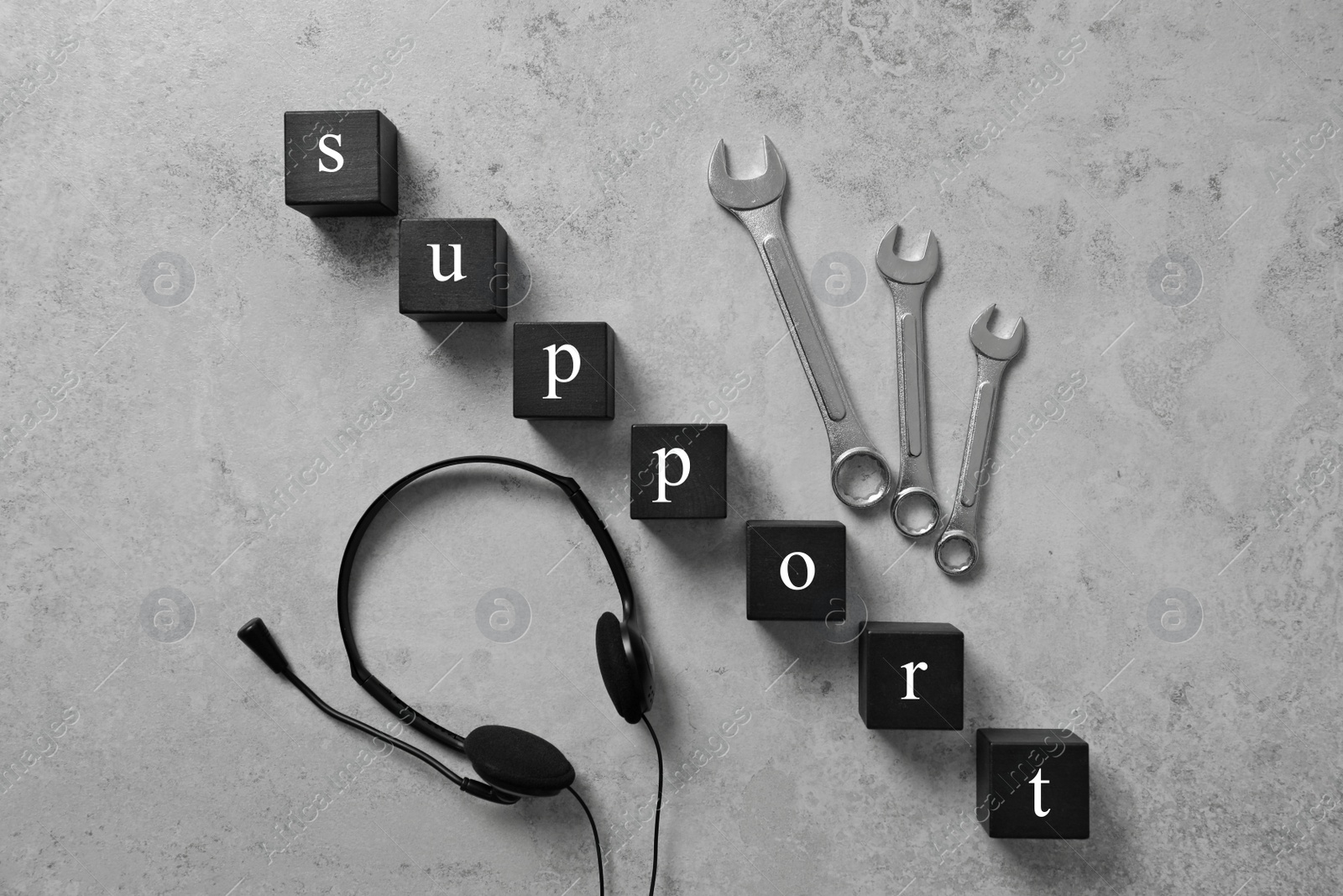 Photo of Flat lay composition with word SUPPORT, headset and wrenches on grey background. Technical service