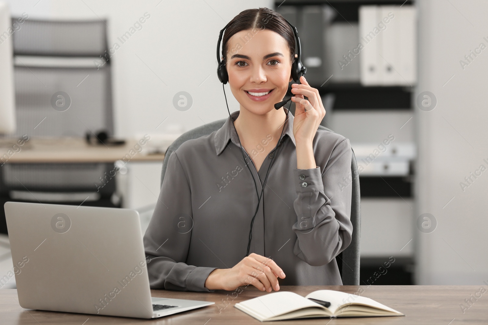 Photo of Hotline operator with headset working in office