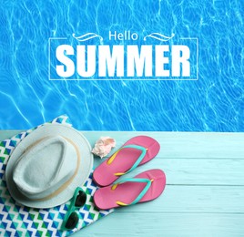 Image of Hello Summer. Beach accessories on light blue wooden deck near swimming pool, flat lay 