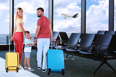 Image of Happy family with suitcases in airport terminal