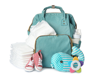 Photo of Backpack with disposable diapers and child's accessories on white background