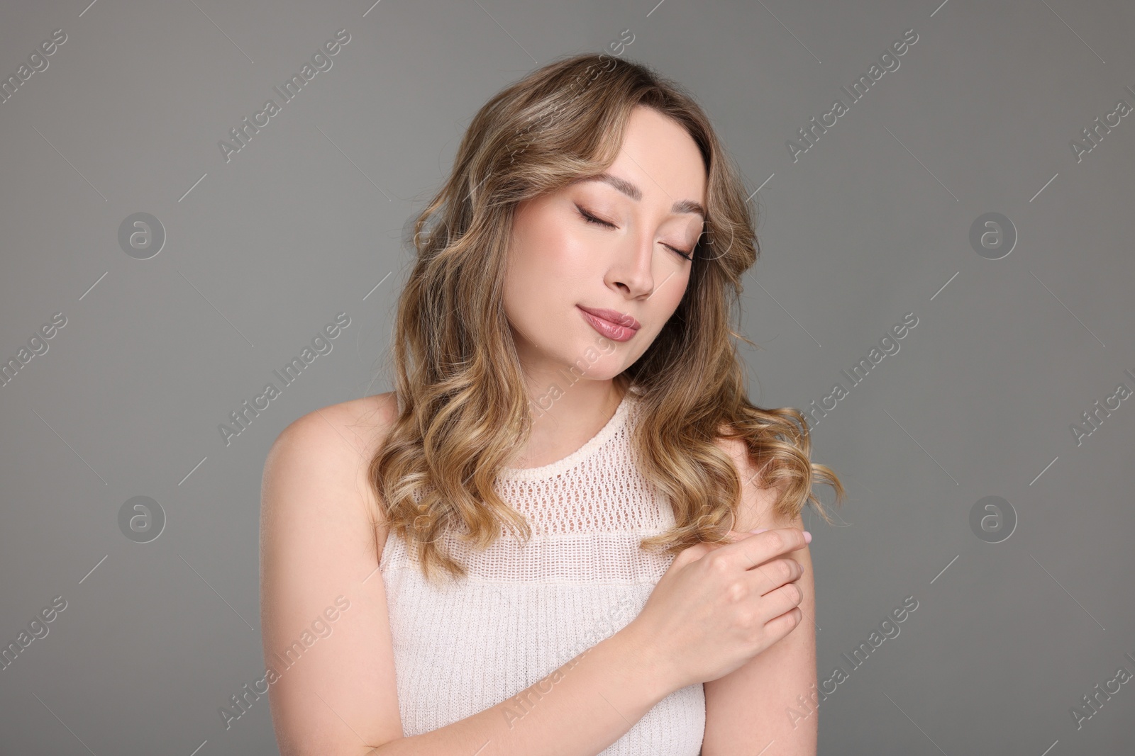 Photo of Portrait of beautiful woman on grey background