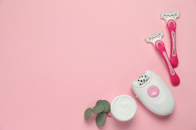 Photo of Modern epilator, razors, cream and eucalyptus branch on pink background, flat lay. Space for text
