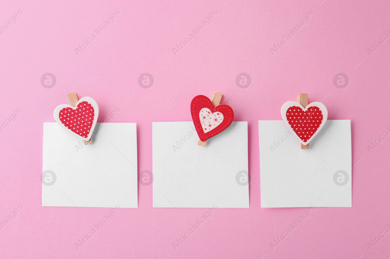 Photo of Blank paper sheets with small hearts on pink background, flat lay. Space for text