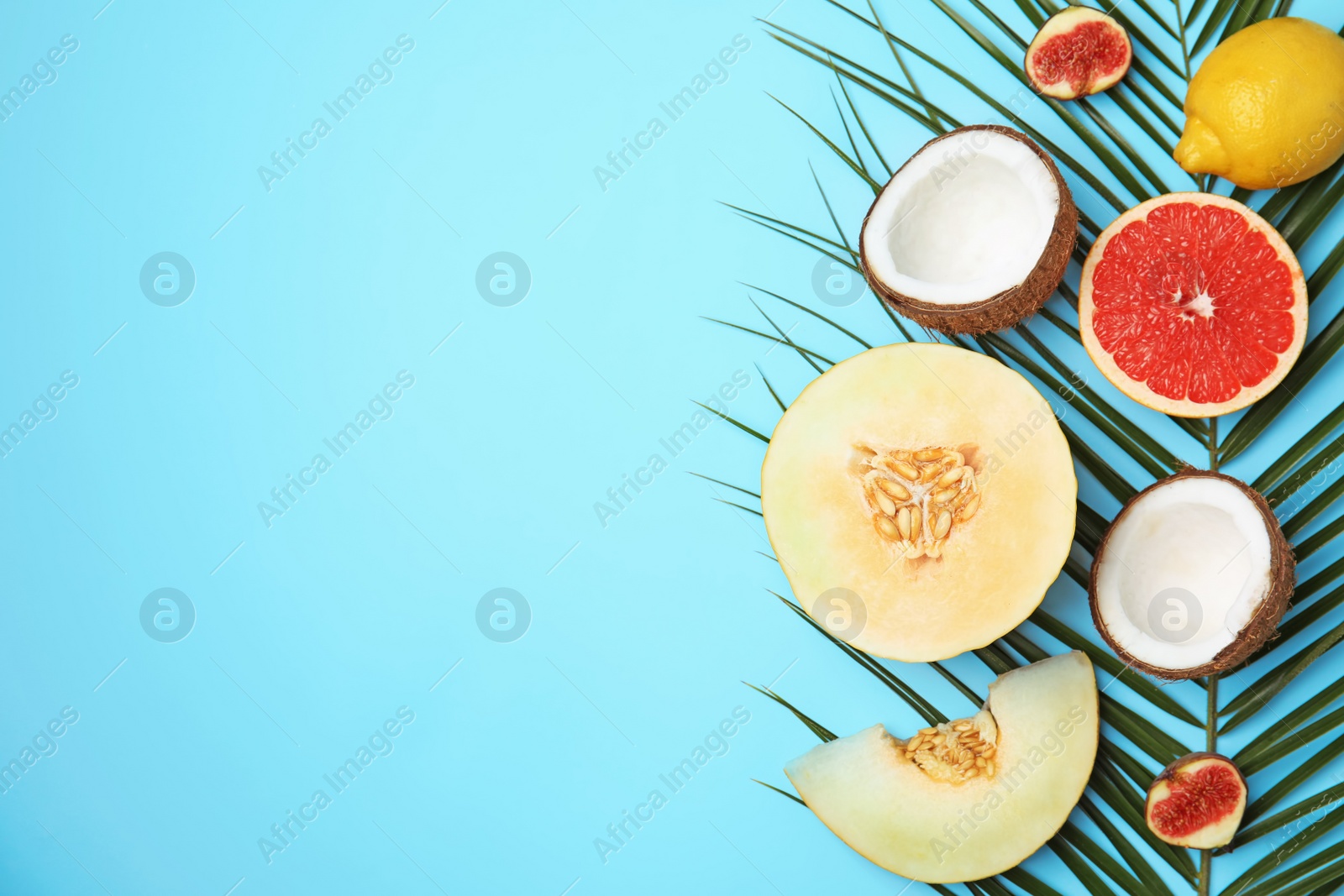 Photo of Flat lay composition with melon, other fruits and space for text on color background