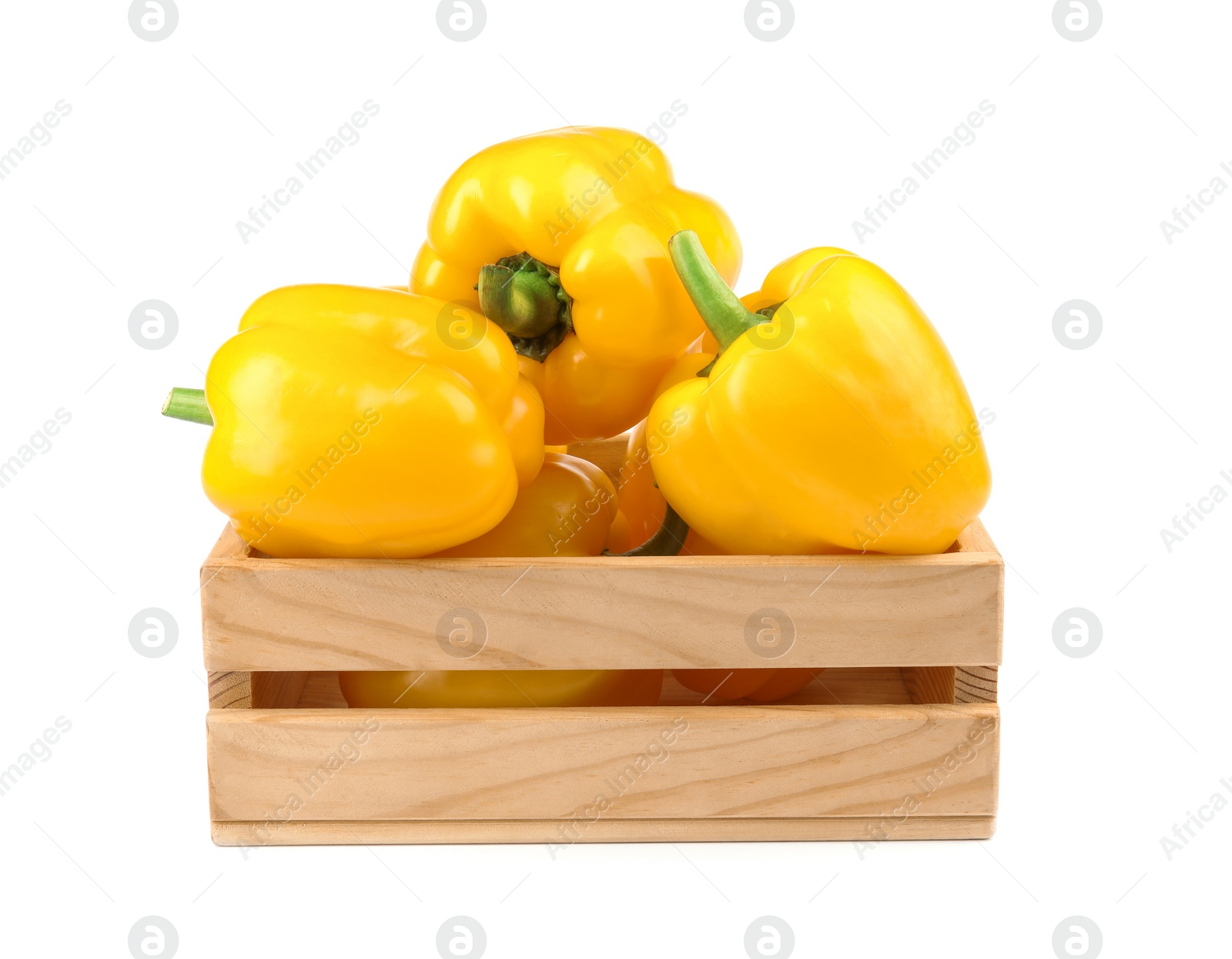 Photo of Crate of ripe yellow bell peppers isolated on white