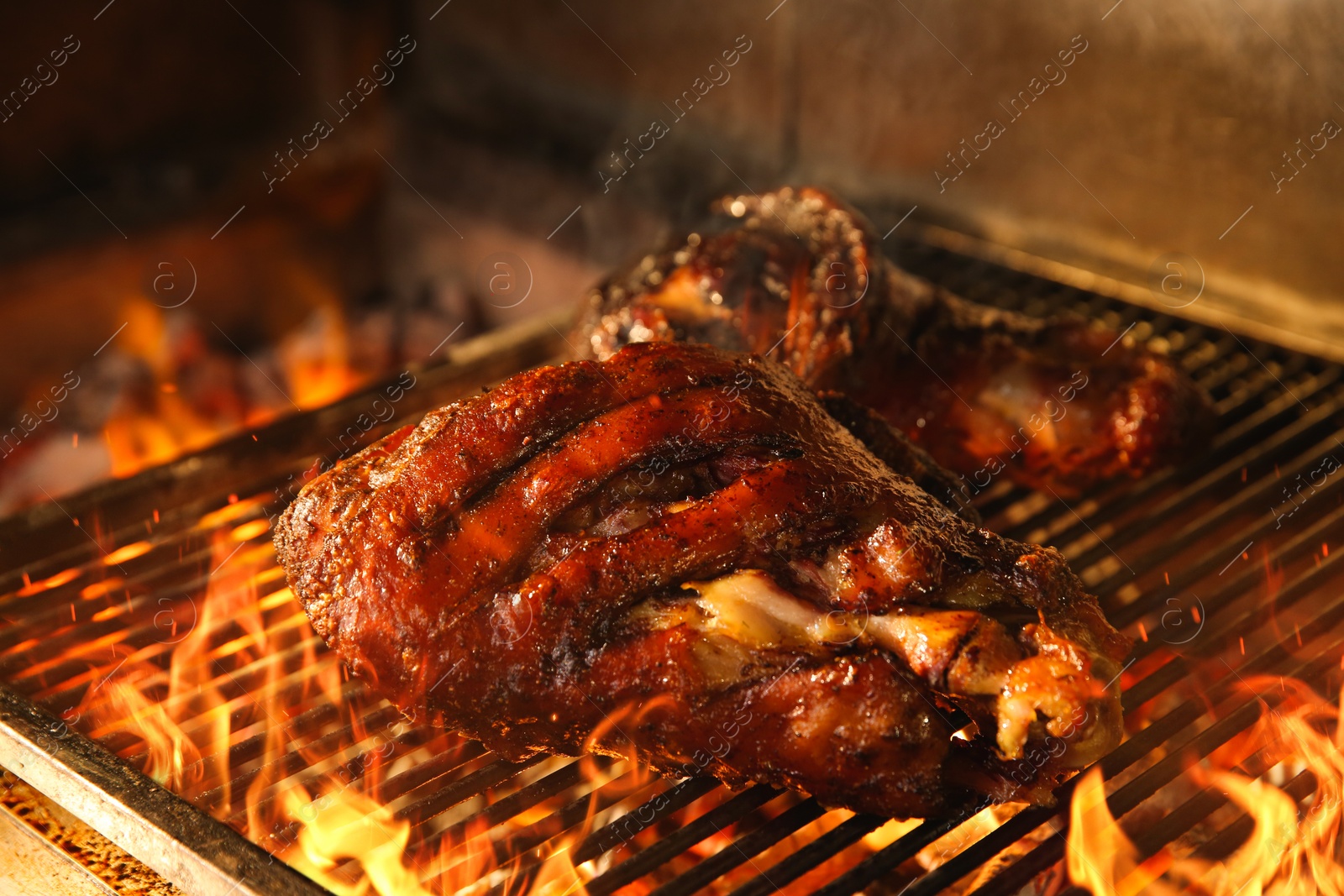 Photo of Grilling grate with pork foreshanks in oven