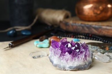 Photo of Beautiful amethyst and different gemstones on table