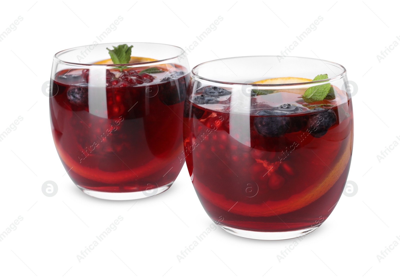 Photo of Aromatic Sangria drink in glasses isolated on white