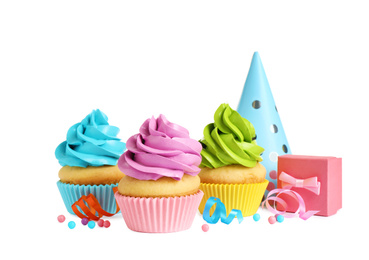Photo of Delicious birthday cupcakes, gift and party cap on white background