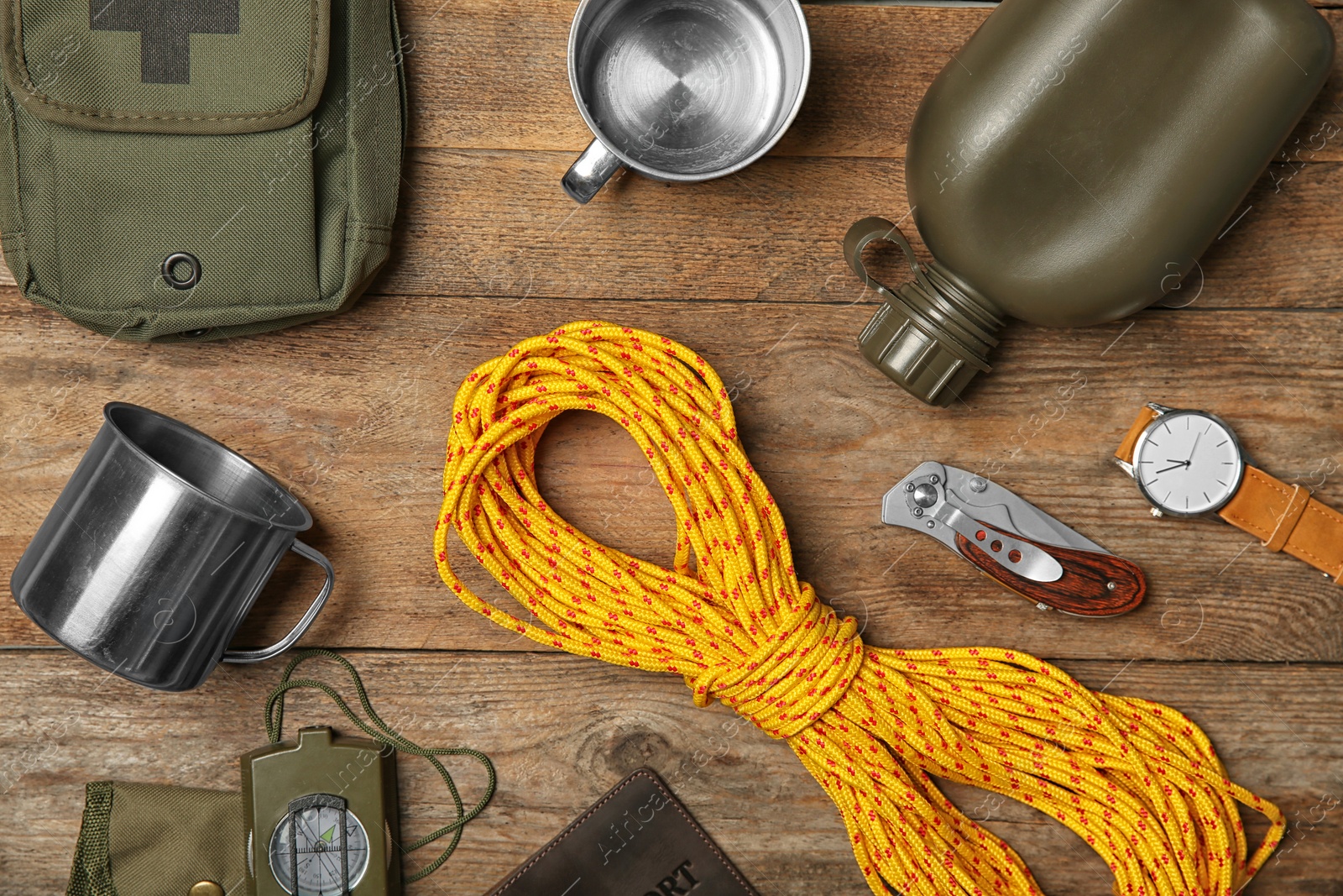 Photo of Flat lay composition with camping equipment on wooden background