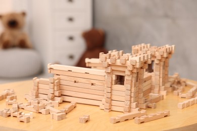 Photo of Wooden construction set on table indoors. Children's toy