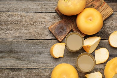 Photo of Freshly made turnip juice on wooden table, flat lay. Space for text