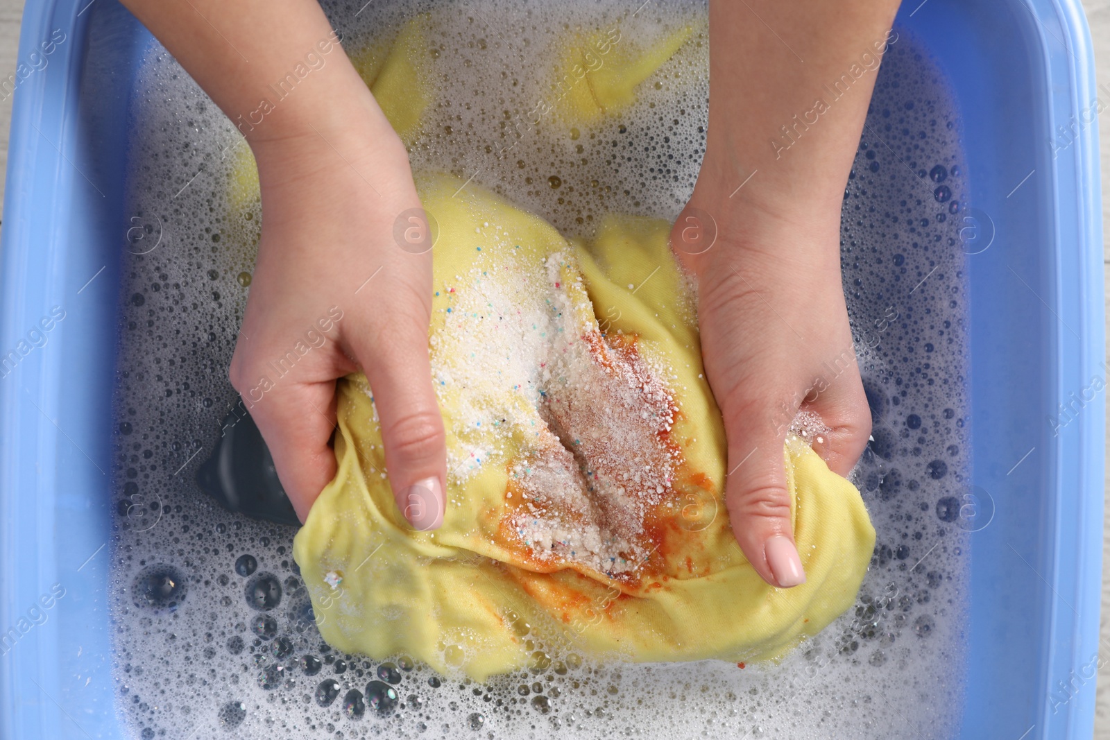 Photo of Woman washing garment with stain, top view