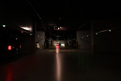 Photo of Modern parking garage with cars at night